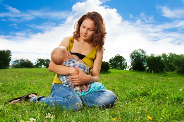 Stock image of mom breastfeeding in bucolic setting by Sergey Novikov/Shutterstock